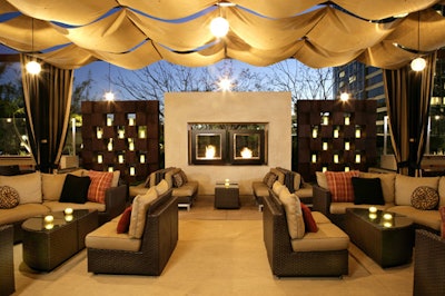 The outdoor patio features a fireplace and a permanent canopy for an indoor atmosphere.