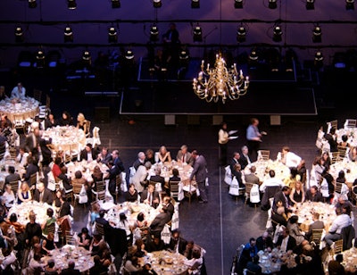 A chandelier and evening-themed blue lighting spruced up the stage where dinner, dancing, an award ceremony, and a live auction took place.
