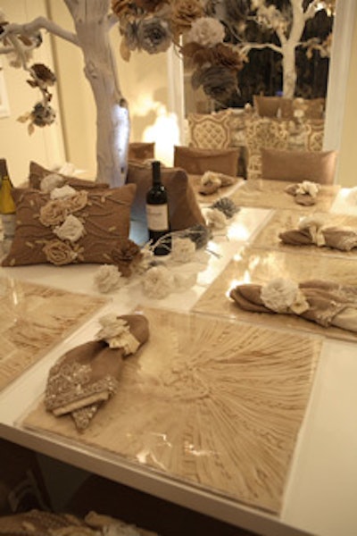 Each setting featured low plexiglass cases of delicate fabric from Ankasa at the company's table for The New York Times.