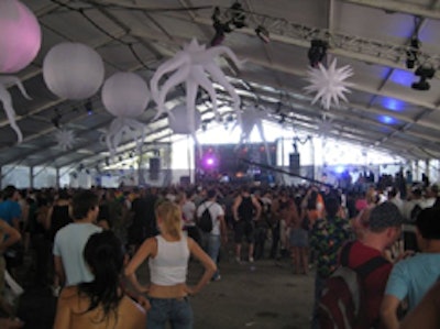 Attendees escaped the heat under the main tent, which was lit up with colorful spheres and stars.