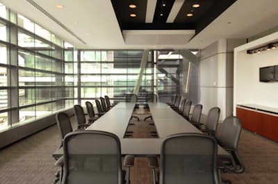 The 720-square-foot boardroom, or '702,' in the conference center is surrounded by glass windows and includes a hollow-square rectangular table that seats 24.