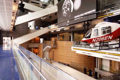 The second-floor balcony overlooks the New York Times–Ochs-Sulzberger Family Great Hall of News, with its 40- by 22-foot LED screen and hanging traffic helicopter.