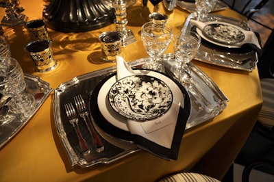 Ralph Lauren Home's goldenrod tablecloth set off black, white, and silver place settings.