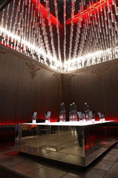 The illuminated, mirrored ceiling of the sleek lounge space for Stolichnaya Elit featured suspended prisms.