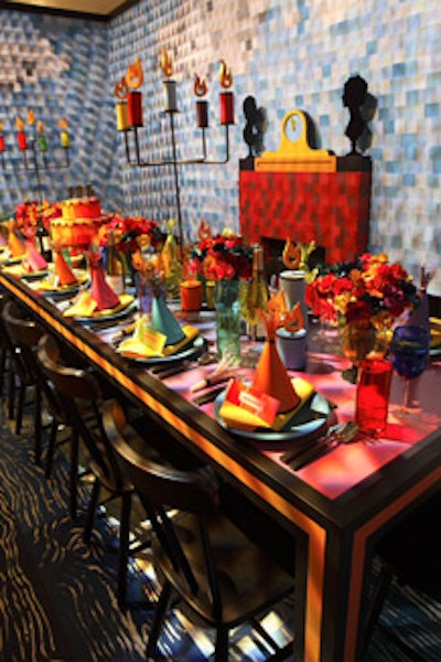 For sponsor Benjamin Moore, David Stark used thousands of paint swatches to give his house-like setting colorful shingles and a cloud-filled sky backdrop. At the table, swatches became party horns and placecards.