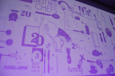 Event decor was mainly limited to wallpaper-like projections of silhouetted cooking items. Designers also incorporated the playful print in the invitations.