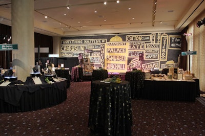 The names of Broadway productions and theaters covered the stage backdrop in the silent auction area.