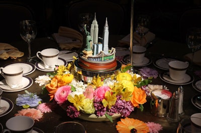 Centerpieces consisted of mini replicas of the New York City skyline that sat on rotating turntables nestled amid renuculas, rose, lilacs, and astromarias.