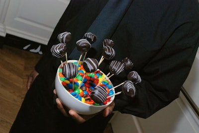 Finger-food desserts included chocolate-dipped cheesecake lollipops presented in dishes of M&Ms.