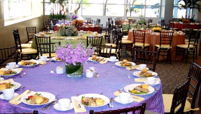 The tables were draped in lilac, orange, sage, and light blue linens courtesy of Destination Planning.