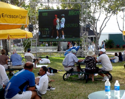 Big-screen TVs were set up in grassy areas throughout the village so that those without tickets into the stadium could enjoy the live matches.