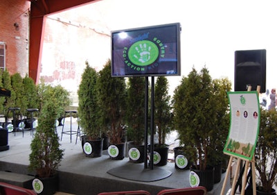 Organizers rented cedar trees from Amherst Greenhouses to create a backdrop on the award stage.