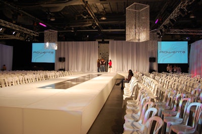 White fabric draped the walls in the runway area, which featured an elevated catwalk surrounded by seating for 500 guests.