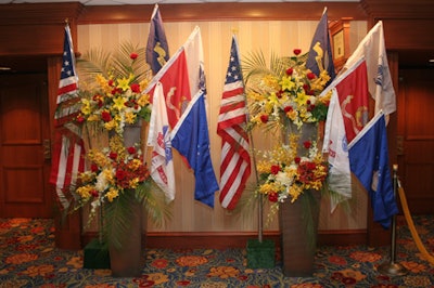 Two tall urns near the reception desk held full-size military flags and colorful floral arrangements.