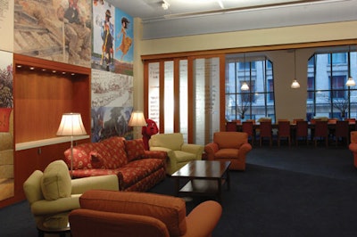Furnished with comfortable couches and an antique boardroom table, the living room holds 75 for receptions.