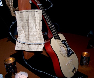 A guitar wrapped in barb wire and the sheet music to 'Back in the Saddle Again' conveyed the evening's theme.