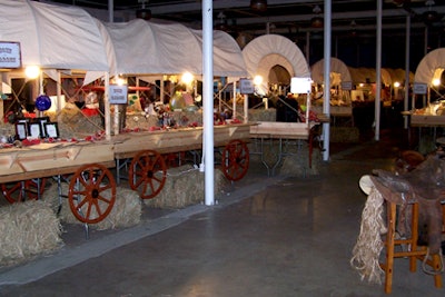 A wagon train, complete with big red wheels and hay barrels underneath, displayed the silent-auction items.