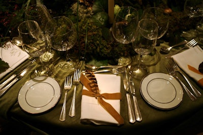 At Emily Thompson Flowers' woodsy table, designers topped each place setting with a feather or a leaf.
