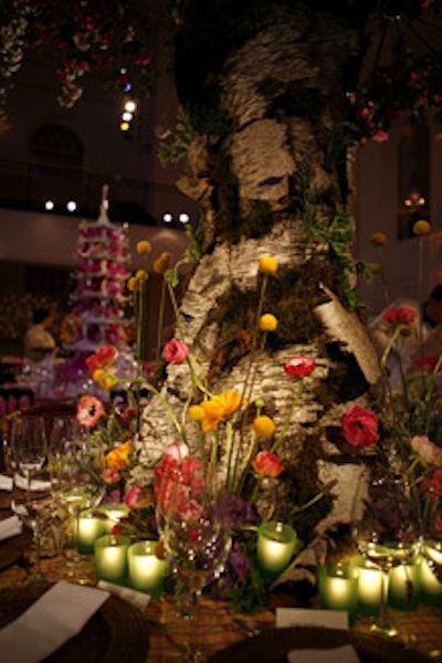 David Beahm crowned his table with a realistic tree bearing azalea and cherry-blossom branches. Spring flowers sprouted around the base of the trunk, which was also surrounded with green votives. A plaid tablecloth, rattan chargers, and bamboo chairs added to the alfresco look.