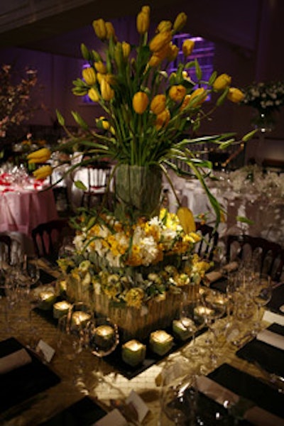 Designers added texture to Renny & Reed's centerpiece by lining it with rows of velvety lamb's ears. The three-level display contained tulips, ranunculus, daffodils, and other seasonal blooms.