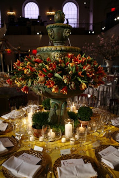 Celebrate Flowers' table had a large working fountain filled with dozens of flame-hued tulips. Wheatgrass and mini topiaries surrounded the base of the fountain.