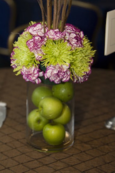 Green apples functioned as centerpieces, topped with blossoms and three-foot-tall branches.