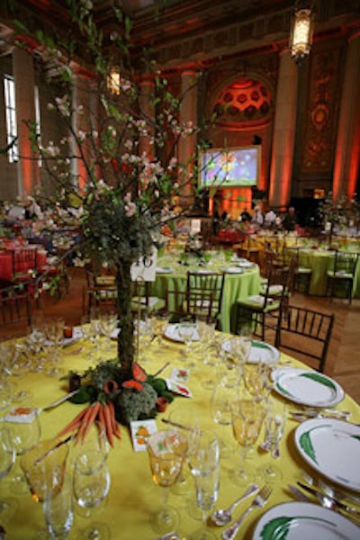The centerpieces alternated from fruits and vegetables to moss-covered blooming quince-branch arrangements by Just Outrageous Events Inc.