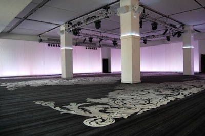 The main room is a blank space equipped with a lighting truss, projection screens on the walls, multiple electrical outlets, and controlled LED lighting.