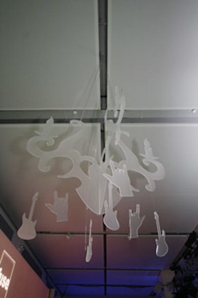 Custom plexiglass chandeliers reflected the genre of each vignette with cut-out shapes like guitars (for rock), stars (for pop), and break dancers (for hip-hop).