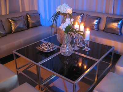 Silver vases filled with white tulips and hydrangeas topped tables in the lounge area.
