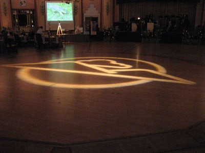 The org's logo lit up the ballroom's storied dance floor.
