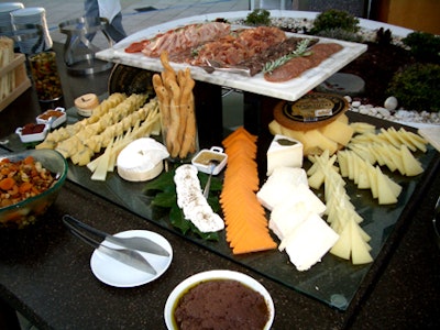 An assortment of cheeses, vegetables, and meats was set up for guests to enjoy.