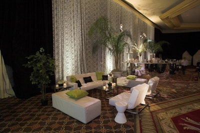 Side lounges featured stark white furniture flanked by tall palms.
