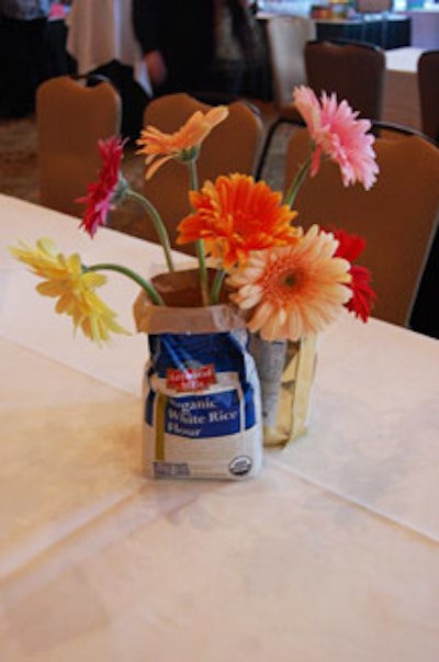 Centerpieces of daisies sprouting from bags of wheat-free flour played off the evening's spring flours theme.