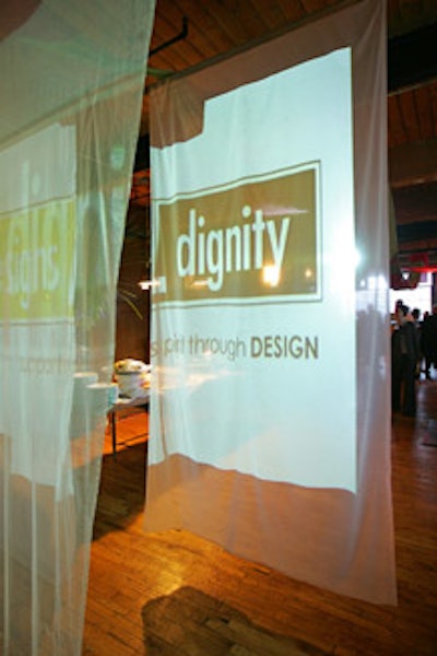 The logo of Designs for Dignity appeared on hanging panels of translucent fabric.
