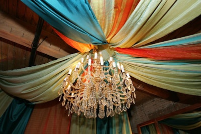 A tentlike ceiling made of reclaimed fabrics hung over the check-in table.