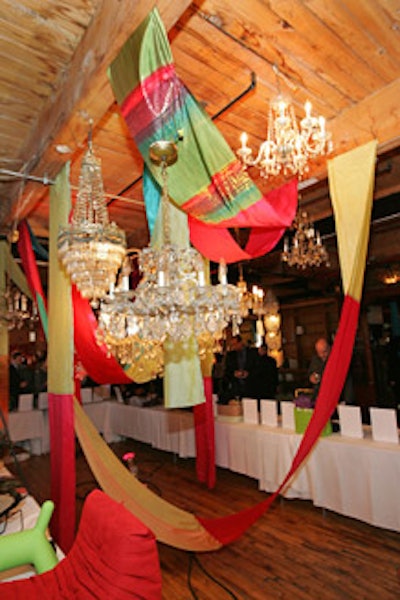 Strips of reclaimed fabric hung amid a cluster of salvaged chandeliers.