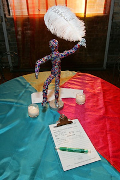 The silent auction continued from the main table to the highboys, where guests could bid on figurines by local artists.