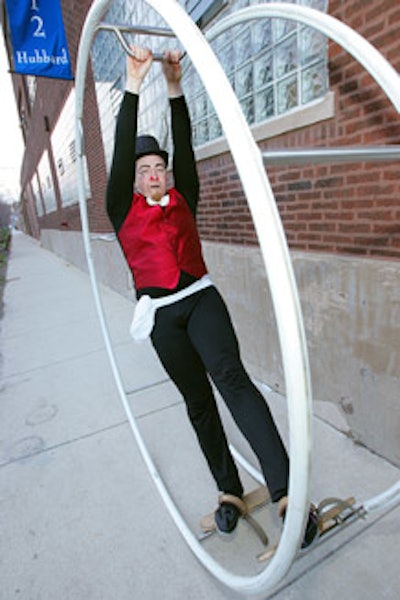 An acrobat from CircEsteem rolled around in a giant wheel outside the Salvage One entrance.