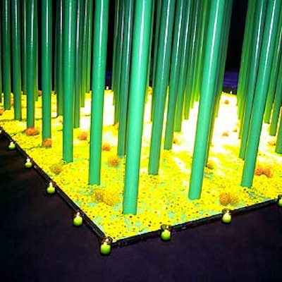 The poles rose from a bed of green stones and yellow pompon flowers.