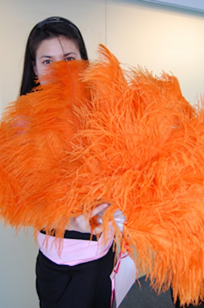 The design of the save-the-dates was based on the two large feather fans that Von Teese uses in her act.