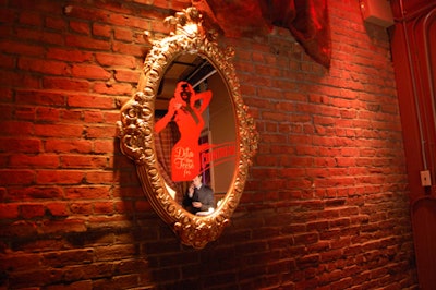 Fake mirrors branded with Von Teese's image dotted the walls.