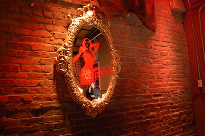 Fake mirrors branded with Von Teese's image dotted the walls.