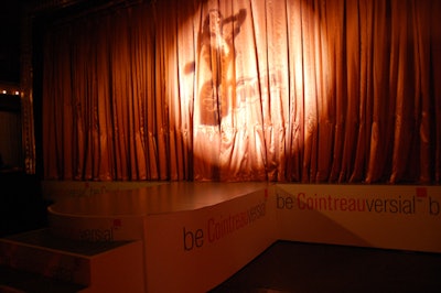 Surrounded by a mock gilded frame, the stage was shrouded with an orange curtain and marked with the campaign's tagline 'Be Cointreauversial.'