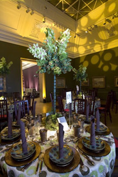 A series of earthy green and brown circular shapes covered the linens in Gallery 29, with matching yellow gobo patterns projected onto the walls.