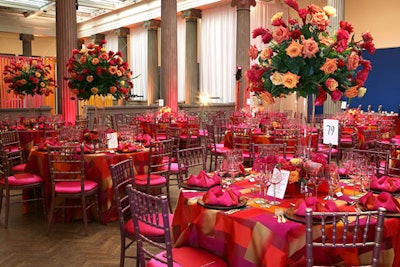 The bridge space, which overlooks the atrium, went for a bright look, with pink and orange linens, metallic plates, miniature pink lamps for votives, and rose and torched-ginger centerpieces.