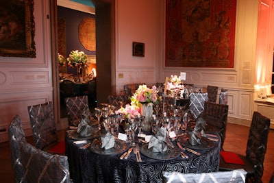 The Little Mantle Room's wood-grain-patterned velvet linens, from the 200-year-old French firm JB Martin Company, inspired the table's centerpiece containers, which were reminiscent of tree stumps.