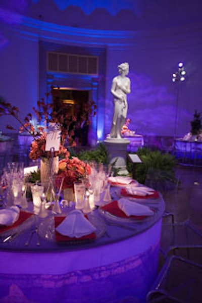 Centerpieces in the rotunda mimicked the photographs of national parks that were printed on the tablecloths. Pictured here is a centerpiece inspired by the Grand Canyon at sunset, mixing ceramic tree trunk containers with kangaroo paws, leonidas roses, gypsy curiousa roses, tiramisu spray roses, and assorted cacti.