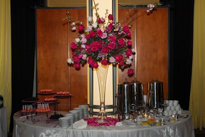 Four-foot-tall arrangements of dark and light pink roses stood in large glass vases.