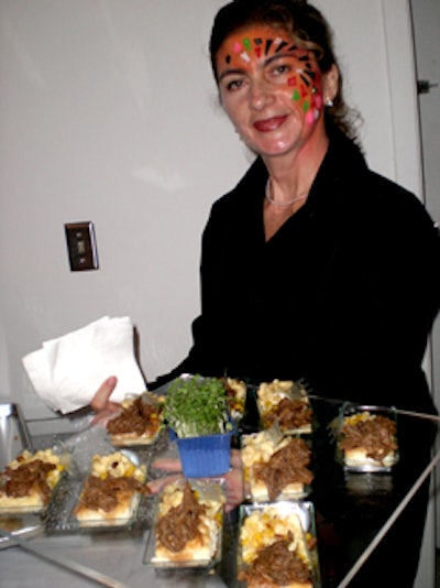 Servers adorned their faces with small mosaic pieces and served small plates of comfort food, including shredded beef, biscuits, and macaroni and cheese.